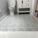 Bathroom with white vanity and patterned tile floor