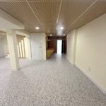 Finished basement room with built-in shelving