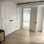 Basement hallway with new doors and flooring